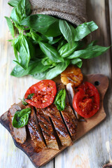 Appetizing juicy steak sliced on a wooden board.