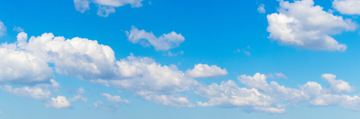 Naklejka na ściany i meble Row of white clouds in the blue sky, panorama