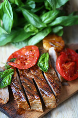 Appetizing juicy steak sliced on a wooden board.