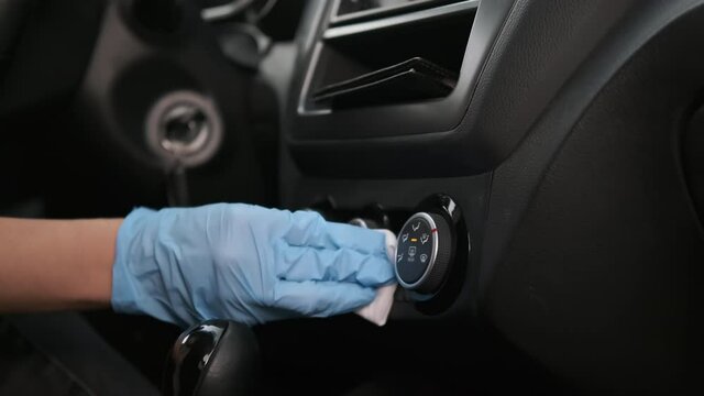 disinfection of interior of automobile, using in car sharing, closeup of hand with gloves