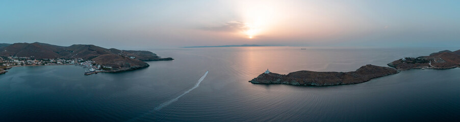 Greece, Kea Tzia island. Korrisia port and lighthouse on a rocky cape, sky, sea background.