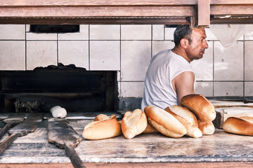 Baker cooking bread at a traditional bakehouse.