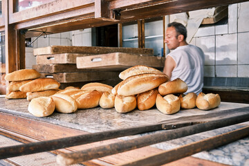 Baker cooking bread at a traditional bakehouse.
