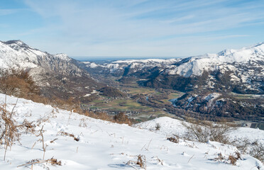 Fototapeta na wymiar View of from Mont de Gez looking south down the valley of the Ousse river with snow-covered mountains in the French Pyrenees, Argelès-Gazost, Hautes-Pyrénées, Occitanie
