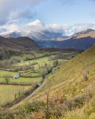 View of valley looking back towards Castet with snow-capped mountains in the French Pyrenees, Castet, Louvie-Juzon, Ossau Valley, Pyrénées-Atlantiques