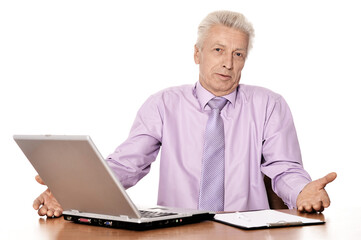 Old businessman  working with laptop isolated on white background