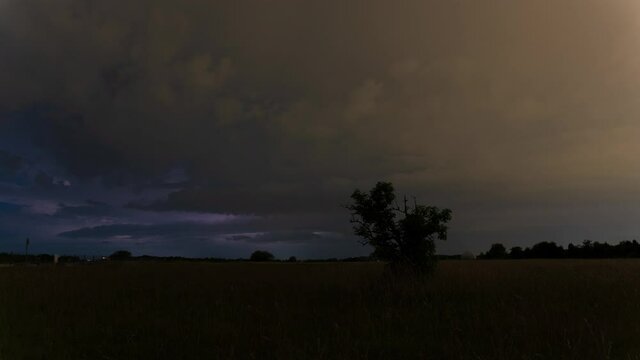 Time lapse of a ferocious thunder storm with many lightnings and fast moving clouds - beautiful colors and dramatic lightning