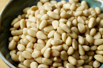Pine nuts (Pinus pinea seed) in a bowl.
