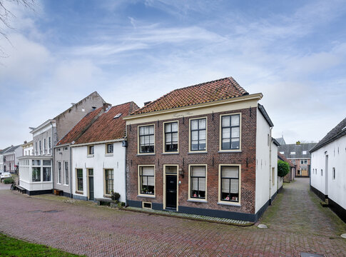 Aan de Weeshuiswal in Buren, Gelderland staat een huis met het opschrift "tempori parce" Wees zuinig met tijd. 