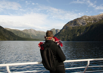 Fototapeta na wymiar young man looking over the side of a catamaran