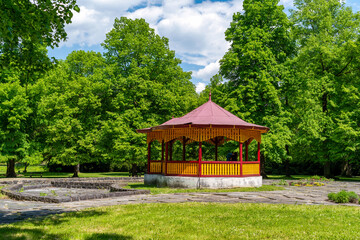 Gazebo in public park between trees