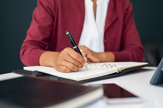 Black Woman Hands Writing On Agenda While Working