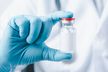 doctor, nurse, scientist hand wear blue gloves holding bottle vaccine, preparing for child, baby,...