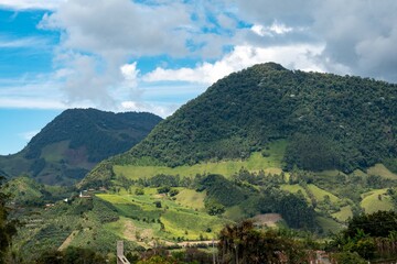 Fototapeta na wymiar Panoramic and rural landscape with blue sky in Jardin, Antioquia, Colombia.