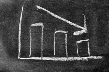 Fototapeta premium White chalk hand drawing in arrow down shape on blackboard or chalkboard background (Concept of stock decline, down trend of business, economy)