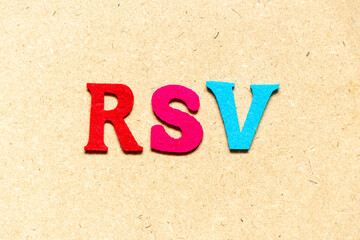 Color cloth alphabet letter in word RSV (Abbreviation of Respiratory syncytial virus) on wood...
