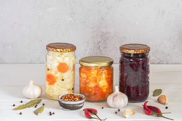Fototapeta na wymiar Homemade fermented food: kimchi cabbage and sauerkraut sour in glass jars with ingredient the white wooden background great for intestinal health. Concept healthy probiotics vegetarian food.