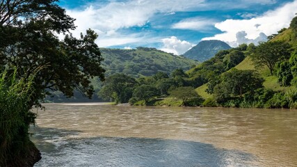Landscape with blue sky and view of the Cauca river. Colombia.