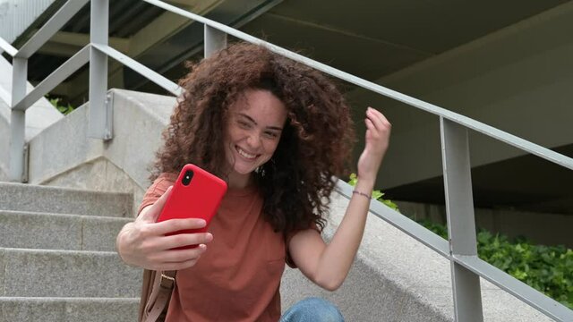 Woman with curly hair taking a selfie 4k.