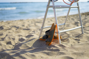 Fototapeta na wymiar men's sandals on the beach in summer time