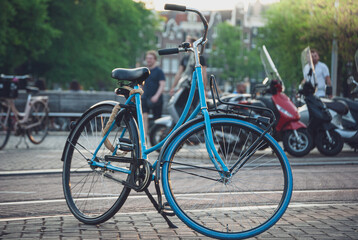 Fototapeta na wymiar Blue vintage bicycle in a Netherlands city with a road