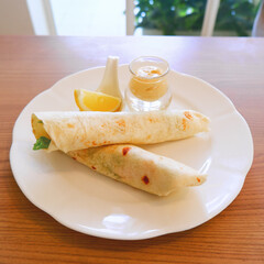 Chicken wrap served with lemon and refreshing sour dressing