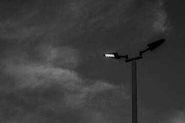 Monochrome of street lighting under blue sky in the evening. lamppost with the sky and cloud in black and white tone.