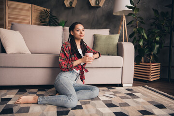 Portrait of attractive girl sitting on carpet drinking cacao pastime free time day at modern loft industrial home indoors