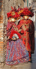 Carnival goers pose for photographs at the Venice Carnival in Italy
