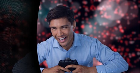 Portrait of man gaming controller against red spots of light against black technology background