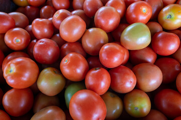 Pile of green and red tomatoes on the market.