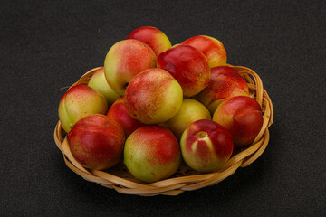 Sweet small nectarines in the basket
