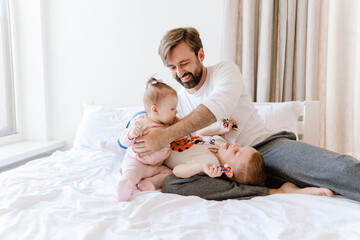 White father playing with his daughter while having breakfast at home