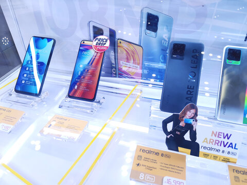 Metro Manila, Philippines - June 2021: Realme cellphones for sale at a booth at a mall. Sample phones on display in a glass cabinet.