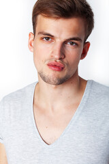 Obraz premium young handsome teenage hipster guy posing emotional, happy smiling against white background isolated, lifestyle people concept