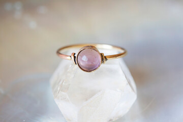 mineral stone brass ring on natural background