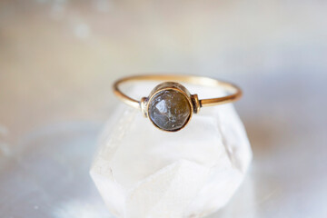 mineral stone brass ring on natural background