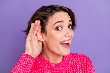 Photo of young excited girl happy positive hands near ear listen news rumor isolated over purple color background