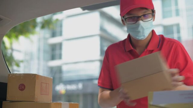 Business concept of 4k Resolution. A delivery worker carrying parcels in the city.