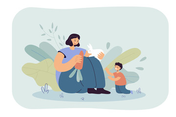 Mom and son feeding carrot to rabbit together. Flat vector illustration. Happy woman and little child sitting with white bunny. Family, parenting, animal, pet, wildlife concept for banner design