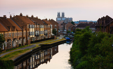 The Minster, beck, and townhouses at sunset, Beverley, Yorkshire, UK.