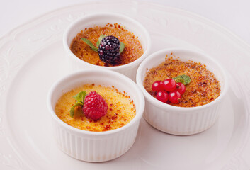 Dessert creme brulee with berries. French vanilla cream dessert with caramelised sugar on top. Delicious dessert for pleasure