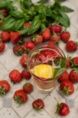 Refreshing drink. Lemonade with strawberries and lemon. Summer cocktail. Strawberry lemonade with basil. Country rest