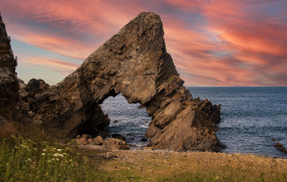 Sunrise at the Needle's Eye, Natural Rock Arch Hole Formation. Macduff, Aberdeenshire, NE Scotland, UK
