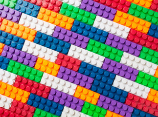background from plastic multi-colored blocks for construction. the children's designer.