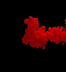 explosion of acrylic red paint in clear water. Black background