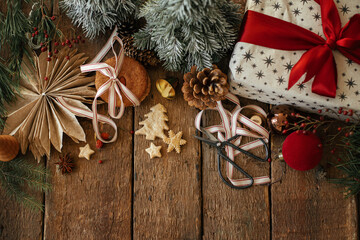 Christmas cookies, stylish gift, festive decorations on rustic wooden table. Atmospheric stylish christmas composition, flat lay with space for text. Xmas present, healthy oatmeal cookies, ornaments