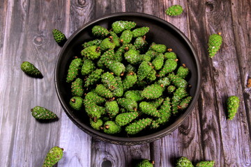 Green Pine Cones. Young green pine cones in the clay  cup, top view.