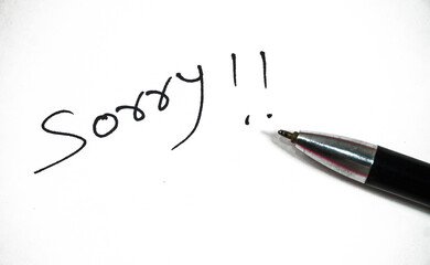hand written sorry in white background