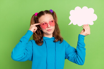 Photo of minded smart little young girl look clod speech think finger temple isolated on green color background